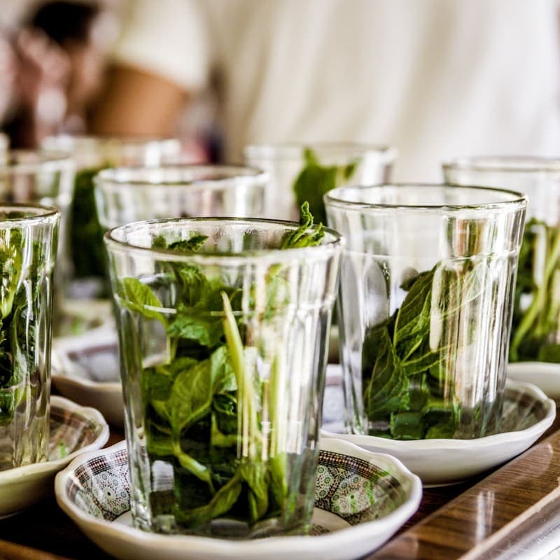 Glasses of fresh mint tea on saucers